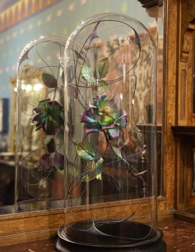 Rose and Thorn Dome £2,600. Twining wire stem, dyed embossed silk satin rose with embossed velvet leaves and rolled straw thorns in antique glass dome. Size H 53 x W 26 x D 26cm Sales: contact Bridget at studio@bridgetbailey.co.uk